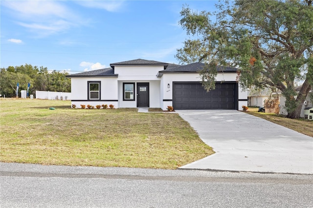 view of front of property featuring a front yard and a garage