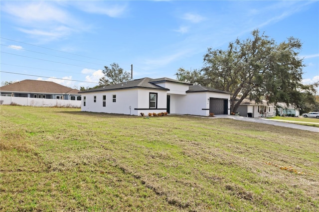 view of front facade with a garage and a front lawn