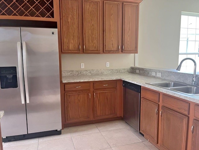 kitchen featuring light tile patterned floors, stainless steel appliances, and sink