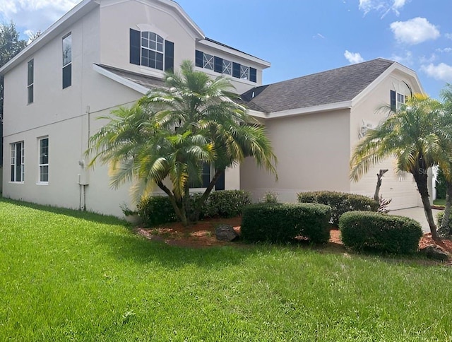 view of property exterior featuring a lawn