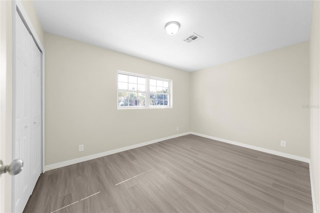 unfurnished bedroom with hardwood / wood-style floors and a closet