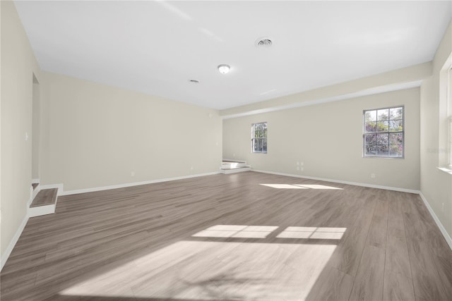 unfurnished room with light hardwood / wood-style floors