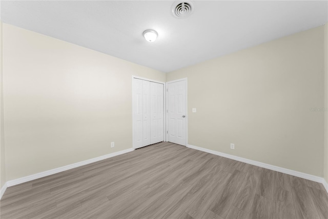 spare room with light wood-type flooring