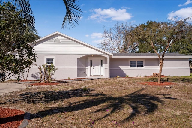 single story home featuring a front lawn