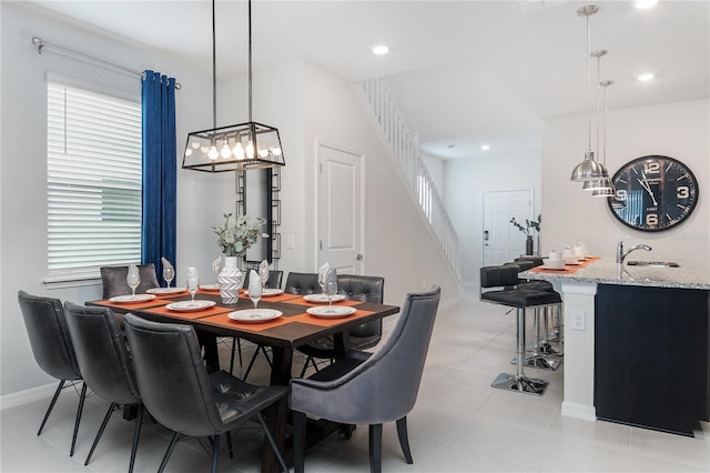 dining space featuring light tile patterned floors and sink