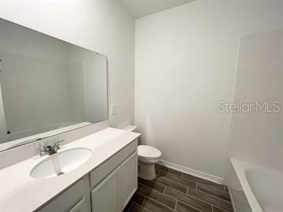 bathroom with vanity and toilet