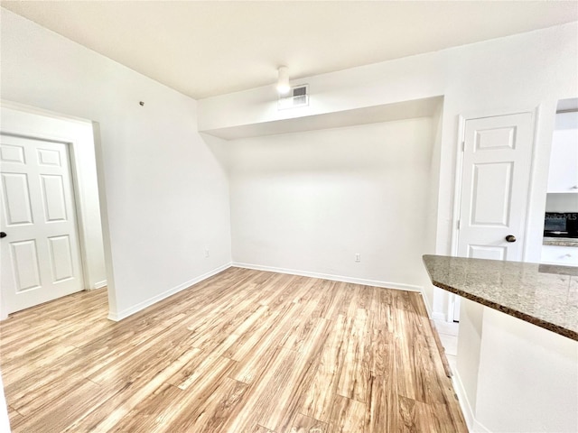 unfurnished dining area featuring light hardwood / wood-style floors