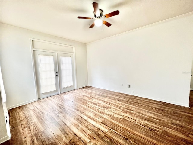 spare room featuring french doors, ceiling fan, ornamental molding, and wood-type flooring