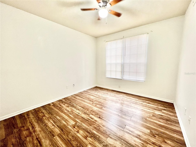 empty room featuring hardwood / wood-style floors and ceiling fan