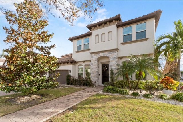 mediterranean / spanish-style home with a front lawn and a garage