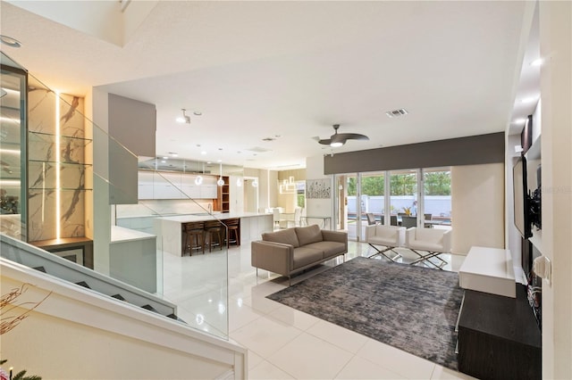 tiled living room featuring ceiling fan