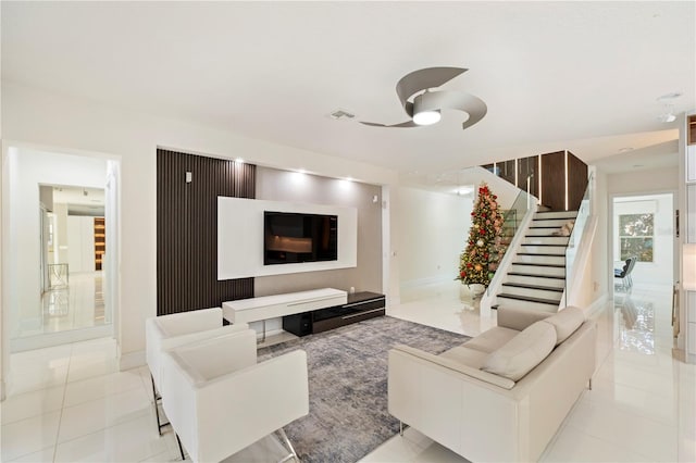 tiled living room with ceiling fan