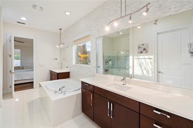 bathroom with tile patterned flooring, vanity, and an enclosed shower