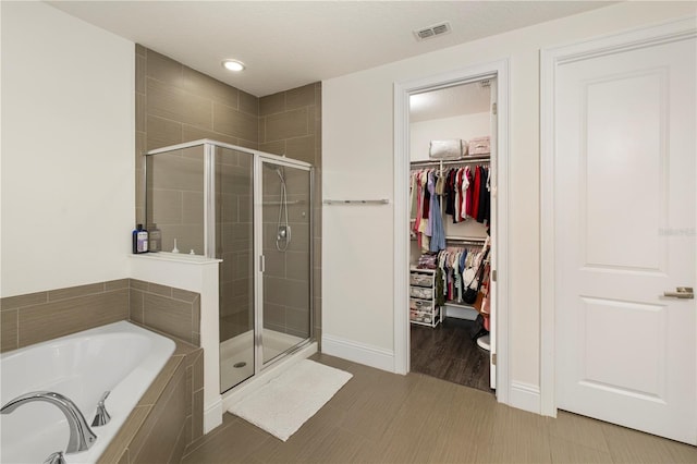 bathroom with separate shower and tub