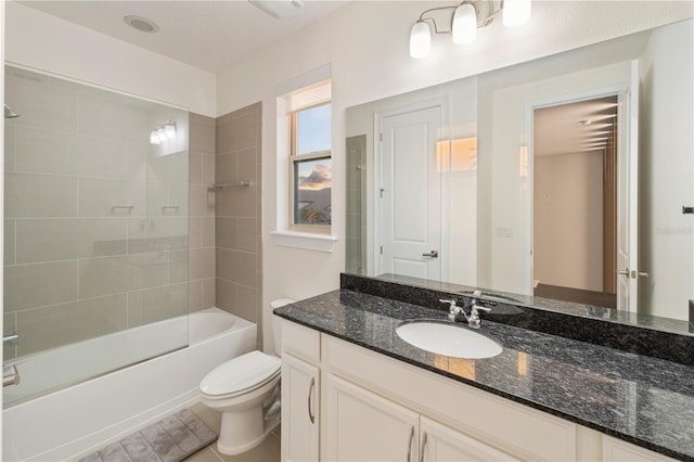 full bathroom featuring tile patterned floors, vanity, toilet, and tiled shower / bath