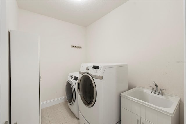 washroom with separate washer and dryer and sink