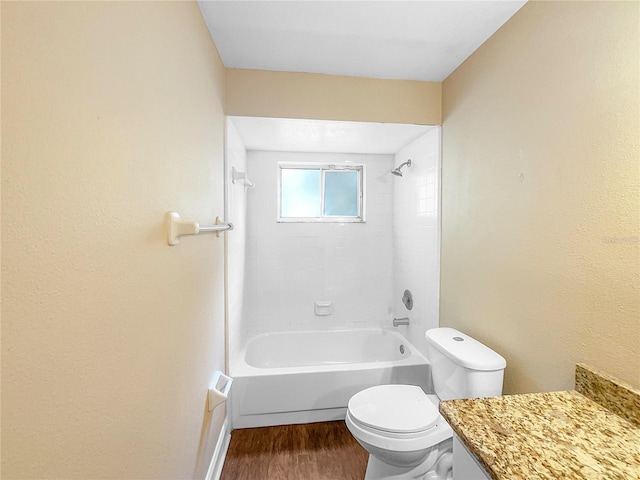 full bathroom featuring hardwood / wood-style floors, vanity, toilet, and tiled shower / bath