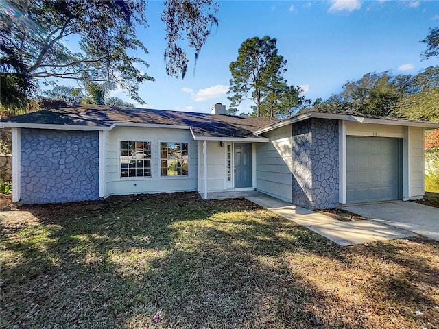 ranch-style home featuring a front lawn and a garage