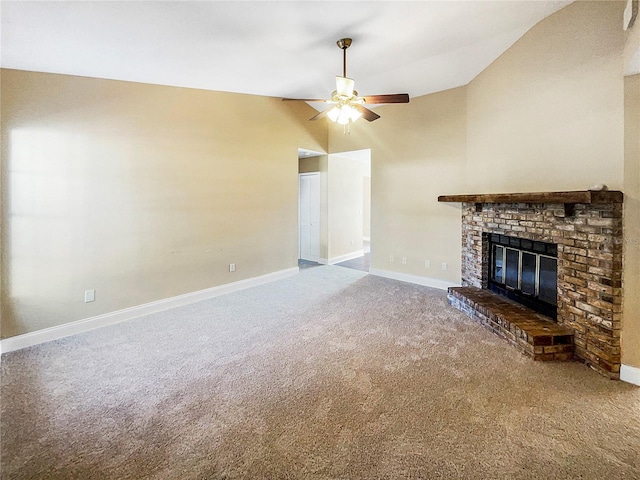 unfurnished living room featuring a brick fireplace, carpet flooring, ceiling fan, and vaulted ceiling