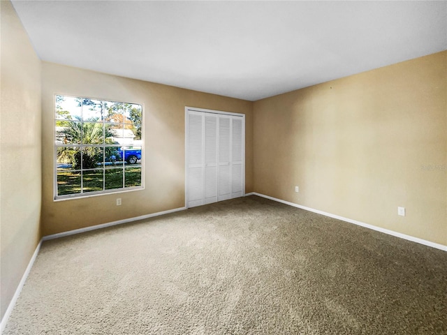 unfurnished bedroom with a closet and carpet floors