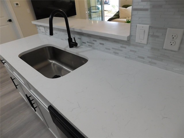 room details with light stone countertops and sink