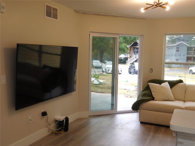 doorway featuring hardwood / wood-style floors and an inviting chandelier