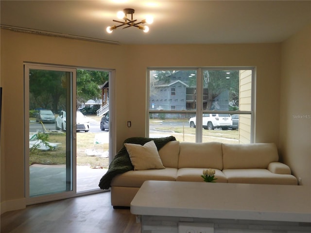 living room with wood-type flooring and a notable chandelier