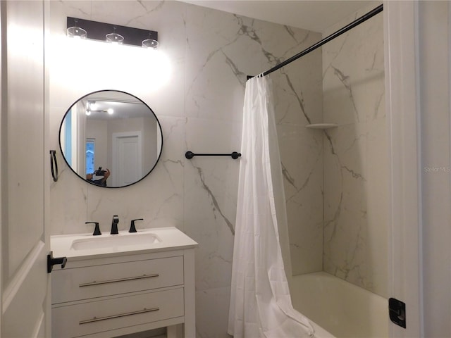 bathroom with backsplash, vanity, shower / bath combo with shower curtain, and tile walls