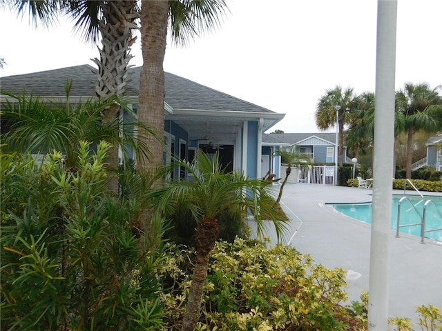 view of swimming pool featuring ceiling fan and a patio area