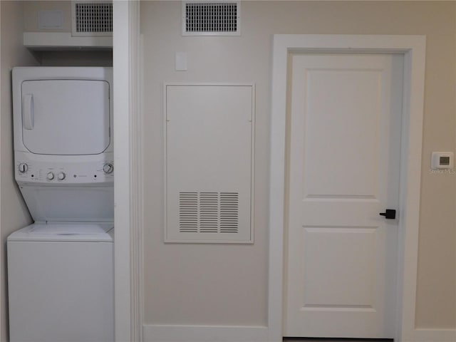 laundry room with stacked washer and dryer