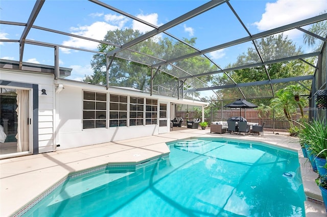 view of pool with a lanai, a sunroom, and a patio