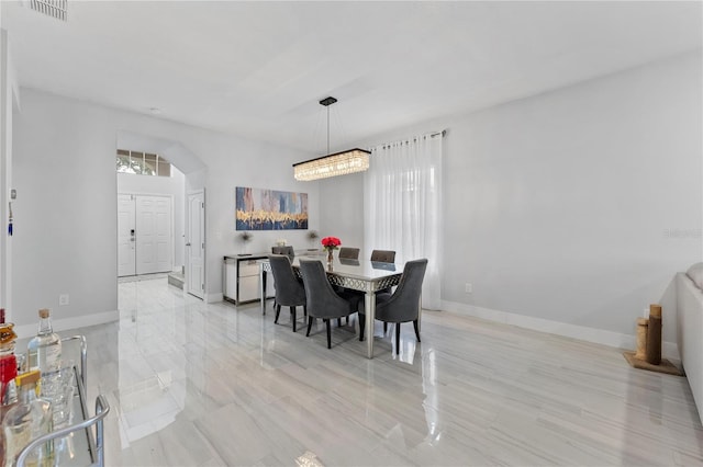 dining space featuring an inviting chandelier