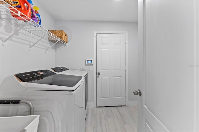 laundry area with washer and clothes dryer and sink