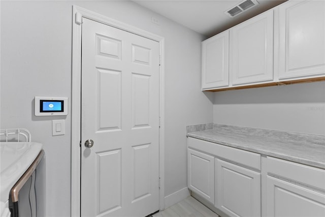 washroom featuring cabinets