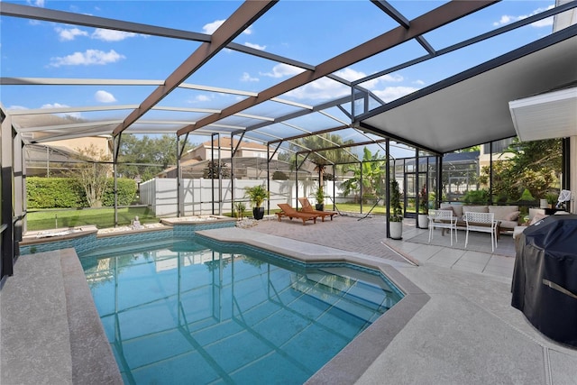 view of swimming pool with outdoor lounge area, area for grilling, glass enclosure, and a patio area