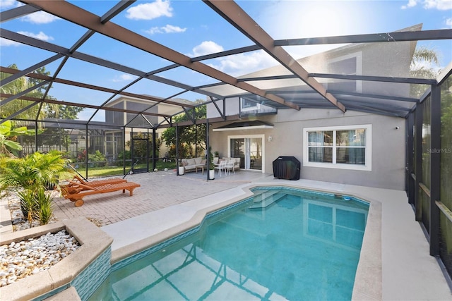 view of pool featuring a lanai, a patio, and an outdoor hangout area