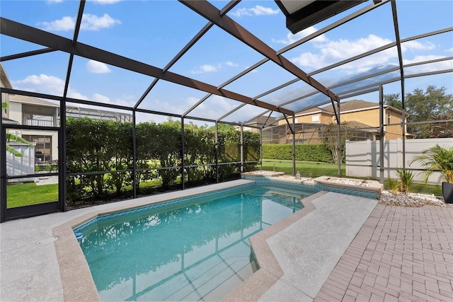 view of pool featuring glass enclosure and a patio area