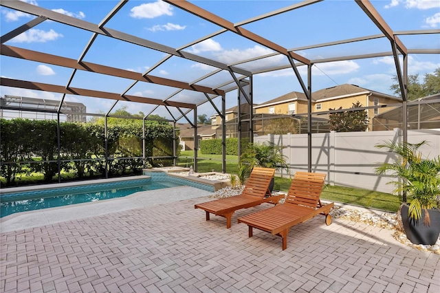 view of swimming pool with a patio and a lanai