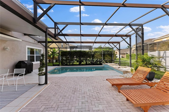 view of pool with area for grilling, a lanai, and a patio area