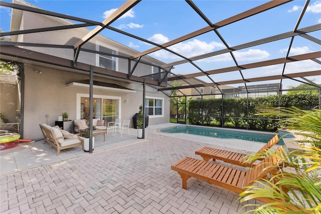 view of swimming pool featuring glass enclosure and a patio