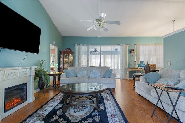 living room with wood-type flooring, vaulted ceiling, and ceiling fan