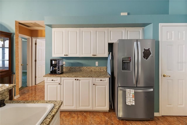 kitchen with white cabinets and stainless steel refrigerator with ice dispenser