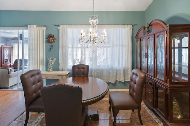 tiled dining space featuring a notable chandelier