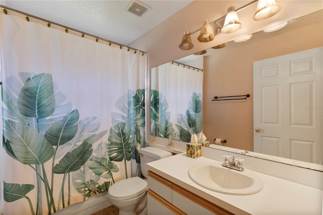 bathroom with vanity, toilet, and lofted ceiling