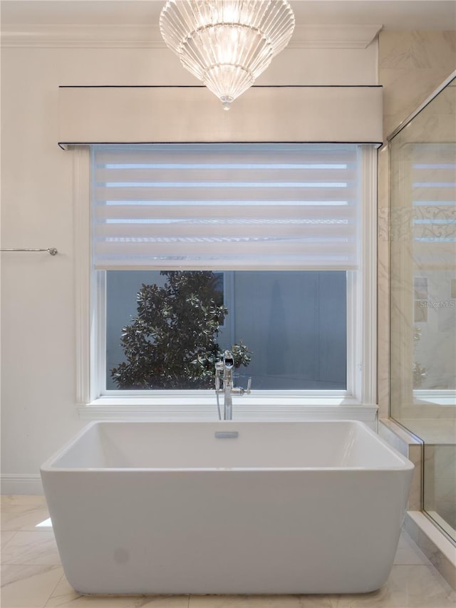 bathroom featuring a tub and a notable chandelier