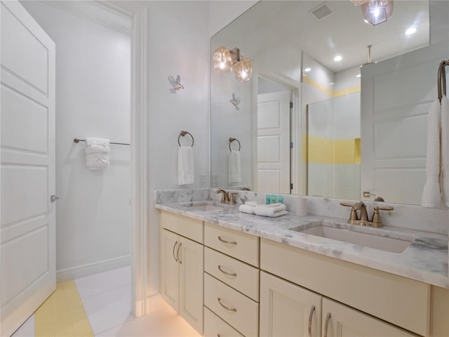 bathroom featuring tile patterned flooring, vanity, and an enclosed shower