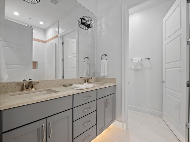 bathroom with a shower, vanity, and tile patterned flooring