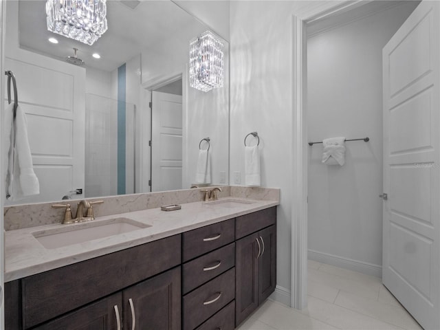 bathroom featuring tile patterned flooring, vanity, walk in shower, and an inviting chandelier