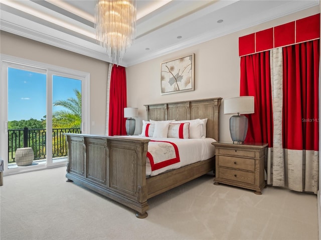 carpeted bedroom featuring a raised ceiling, a notable chandelier, access to exterior, and ornamental molding