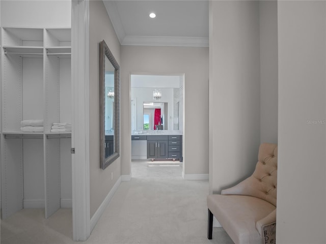 hallway featuring crown molding, light colored carpet, and a notable chandelier